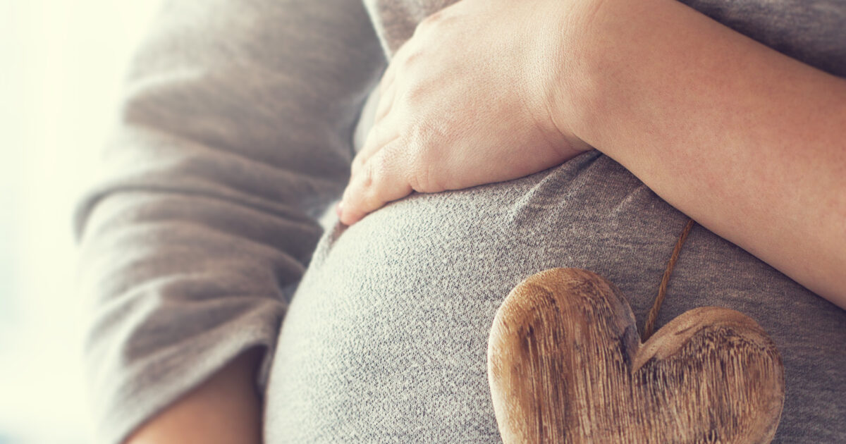 image-young-pregnant-woman-holds-wooden-heart-love-concept-pastel-to